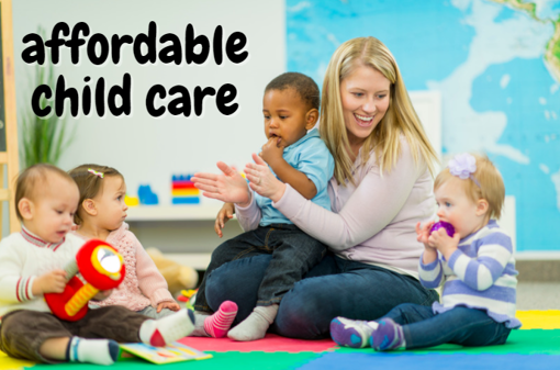 educator sitting on the floor with young children clapping hands